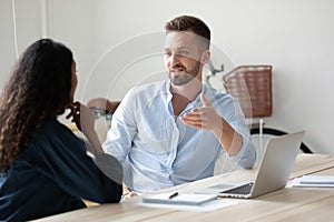 Diverse colleagues discuss business ideas in office