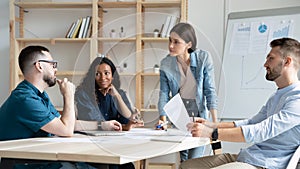 Diverse colleagues discuss business ideas at office briefing