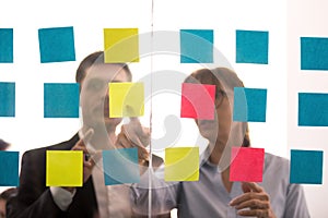 Diverse colleagues discuss ideas shared on sticky notes