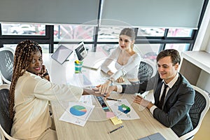 Diverse colleagues gather putting their hands together. Stack of hands. business people putting their hands together