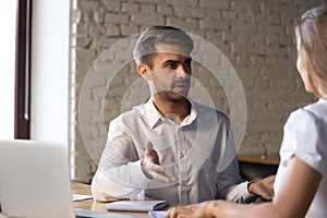 Diverse colleagues have conversation discussing business project