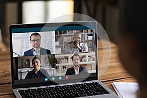 Diverse colleagues have online team meeting on laptop