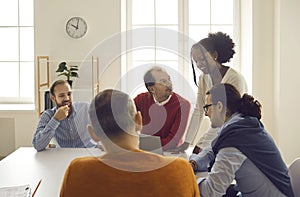 Diverse colleagues thinking over business project strategy in corporate office meeting