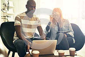 Diverse colleagues working online together in a stylish office