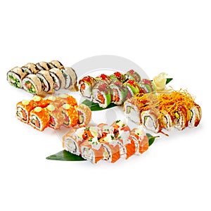 Diverse collection of specialty sushi rolls on bamboo leaves