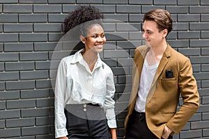 A Diverse couple - Multi-ethnic couple in love. African American woman and a Caucasian man standing background wall. Portrait of a