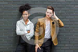 A Diverse couple - Multi-ethnic couple in love. African American woman and a Caucasian man standing background wall. Portrait of a