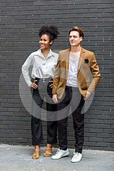 A Diverse couple - Multi-ethnic couple in love. African American woman and a Caucasian man standing background wall. Portrait of a