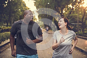 Diverse couple running at the park