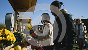 Diverse couple at the stall choosing products