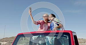 Diverse couple takes a selfie on road trip with copy space on road trip, slow motion