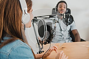 Diverse coworkers recording podcast in studio
