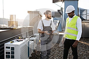 Diverse craftsmen standing and discussing issues outdoor