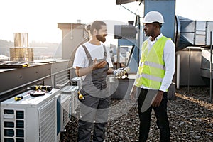 Diverse craftsmen standing and discussing issues outdoor