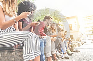 Diverse culture friends using smartphones outdoor - Group of happy people having fun with technology trends - Youth, new