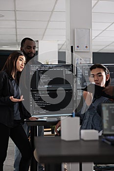 Diverse database developers discussing about html code on terminal window