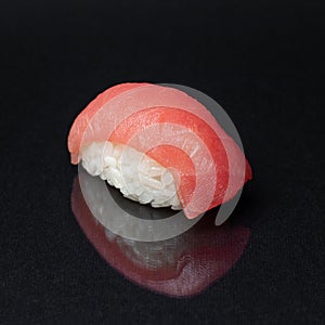 Diverse delicious sushi roll set on a black background with reflection, menu