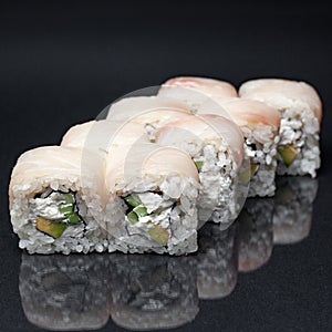 Diverse delicious sushi roll set on a black background with reflection, menu