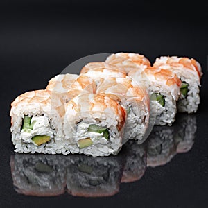 Diverse delicious sushi roll set on a black background with reflection, menu