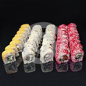 Diverse delicious sushi roll set on a black background with reflection, menu