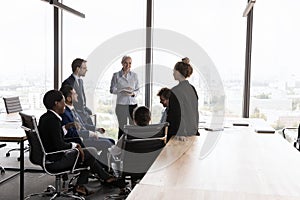 Diverse different aged business group meeting in open office space