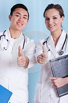 Diverse doctors with okay gesture