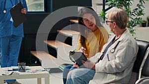 Diverse elderly women analyzing checkup report on digital tablet