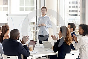 Diverse employees applaud thanking coach for training photo