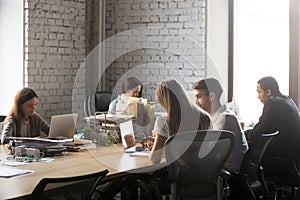 Diverse employees busy working in shared office photo