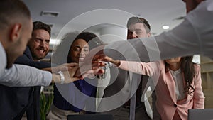 Diverse employees celebrate success. Business team high five on office meeting.