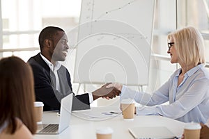 Diverse employees handshake getting acquainted at briefing