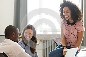 Diverse employees take break during working day laughing feels relaxed