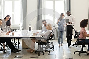 Diverse employees using computers, working together at coworking