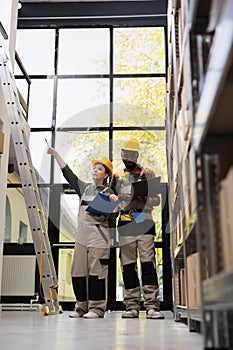 Diverse employess wearing helmet and protective overall