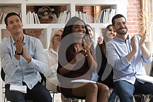 Diverse entrepreneurs seminar participants clap hands expressing gratitude for speech