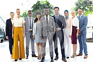 Diverse executives all looking to camera in hall