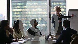 Diverse executives discussing new business plan with female speaker