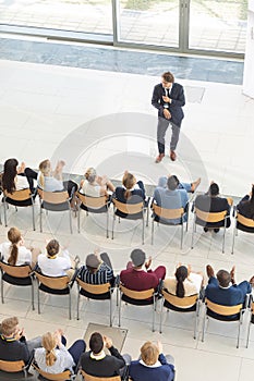 Diverse executives sat in conference room, looking speech