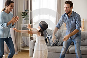 Diverse family playing hide and seek at home photo
