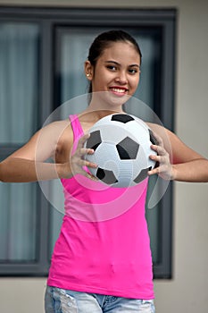 Diverse Female Athlete Smiling With Soccer Ball