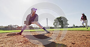 Diverse female baseball players, fielder on base catching out a running hitter on baseball field