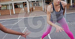 Diverse female basketball team playing match, dribbling ball