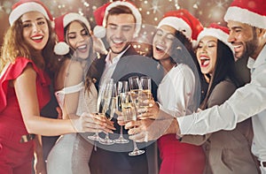 Diverse friends clinking with champagne glasses on New Year`s Eve