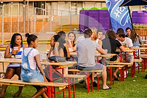 Diverse Friends eating, drinking and generally enjoying a day out at a outdoor beer garden