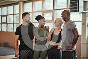 Diverse friends laughing together after working out a the gym