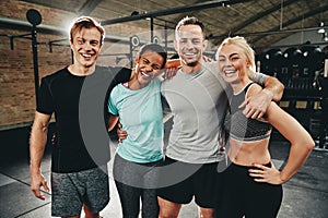 Diverse friends laughing after a workout at the gym