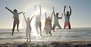Diverse friends leap joyfully on a sunny beach
