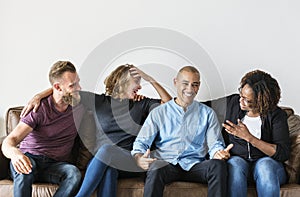 Diverse friends talking to each other on couch