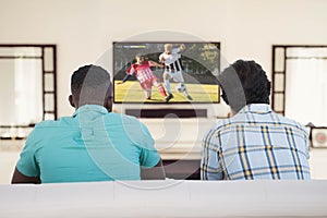 Diverse friends watching tv with football match on screen