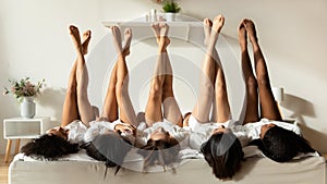 Diverse girls lie upside down celebrate hen party